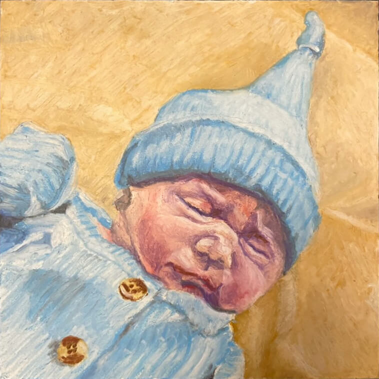 Portrait of days old infant in blue sweater and matching hat by portrait artist, Dominic White